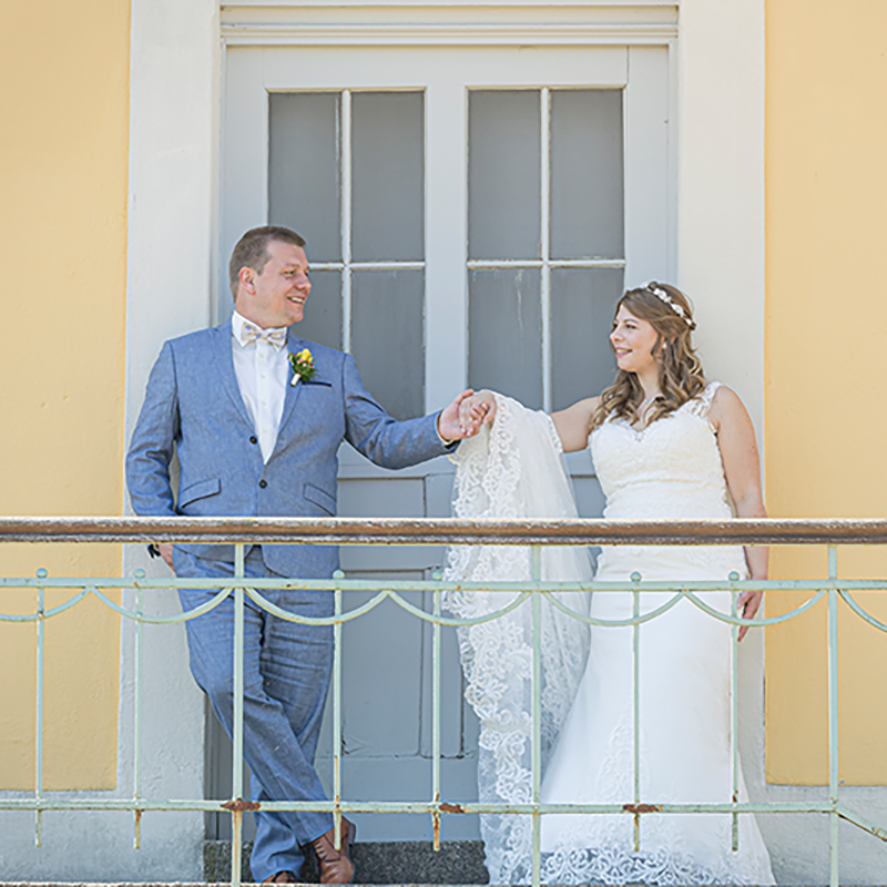 Romantik pur: Brautpaar auf dem Balkon. Händchenhaltendes Brautpaar auf Balkon, Aufnahme von Bildwerk Ansbach.